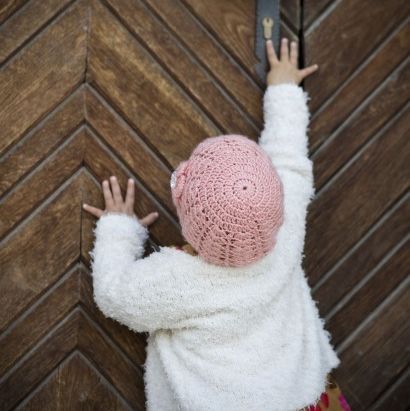 child reaching up a door