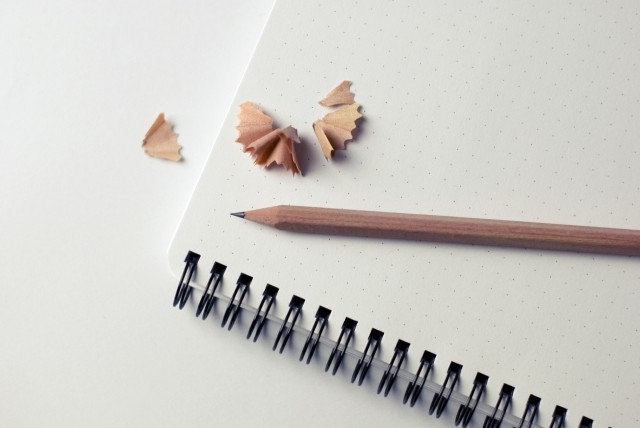 pencil on a notebook with pencil shavings